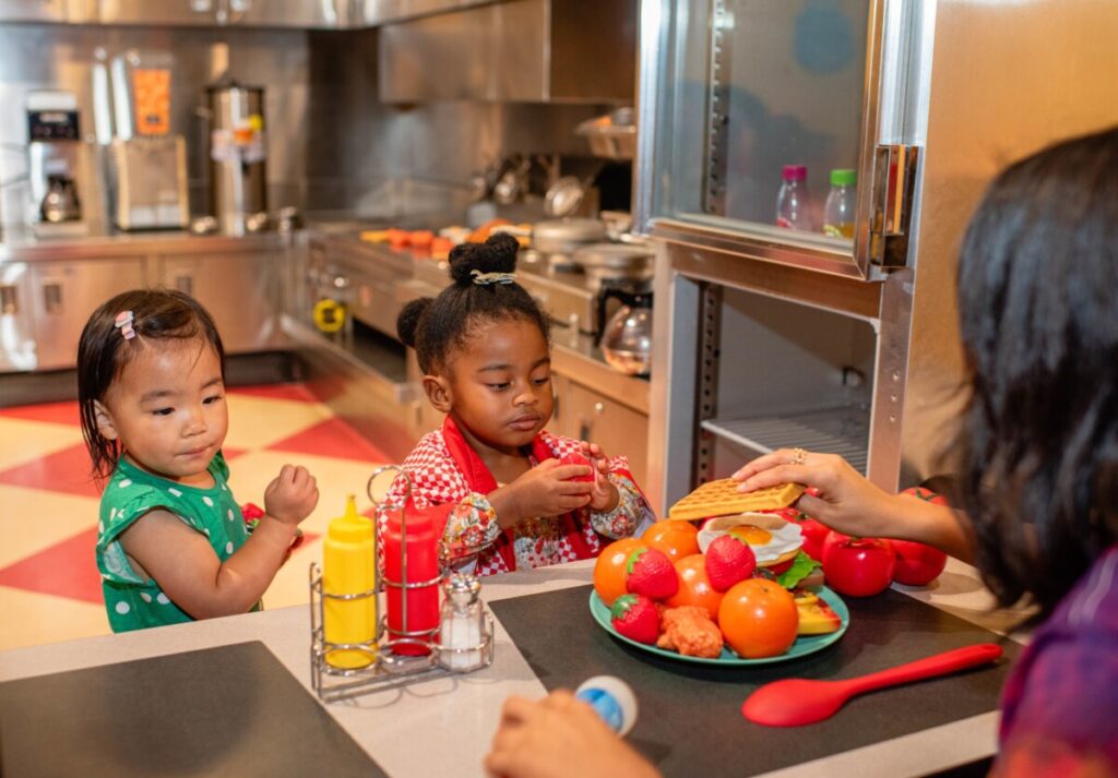Children playing in the kitchen exhibit at Children’s Museum of Atlanta