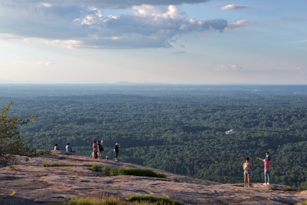 Visitors looking across the forest from the Stone Mountain summit
