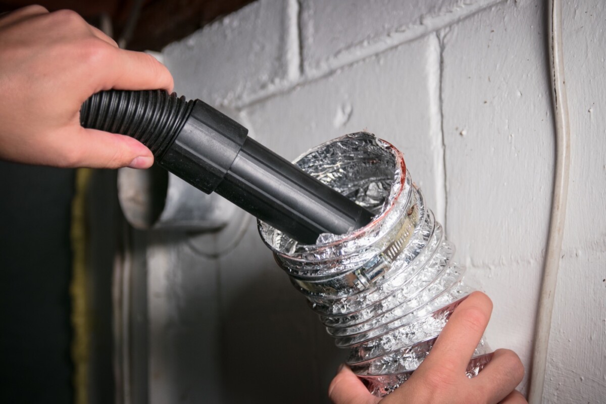 Vacuum removing lint from a flexible dryer vent hose