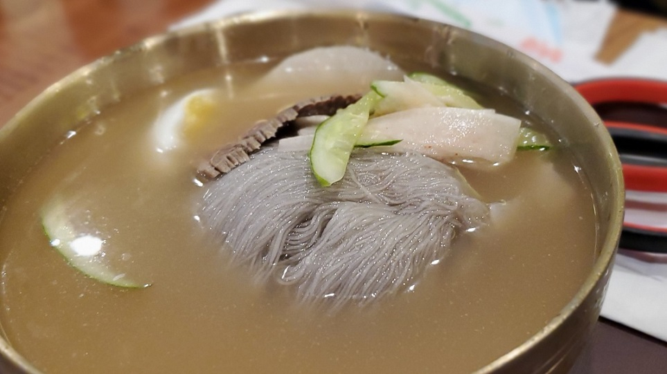 Bowl of mul naengmyun with chewy noodles and chilled broth